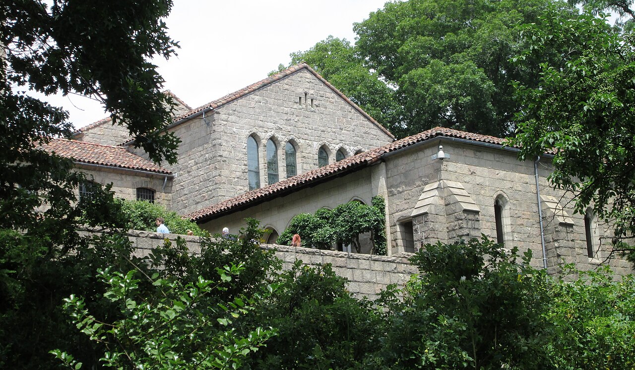 The stone Met Cloisters building and gardens on the hilltop in Fort Tryon Park