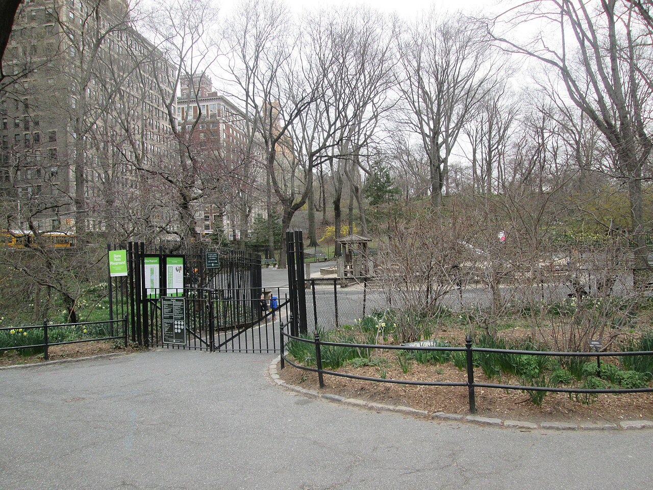 Children climbing a rope net and slides at Diana Ross Playground in Central Park